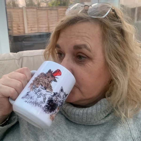 woman drinking from a cat mug